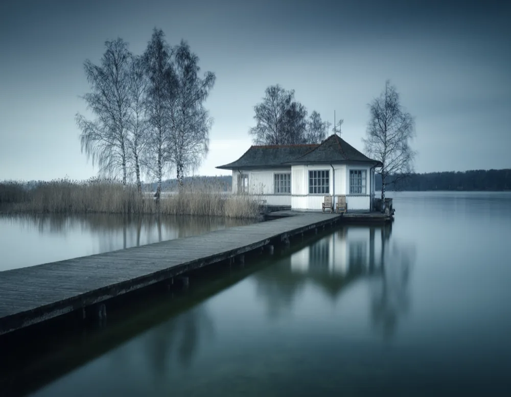 The jetty at Haus Weißensee reaching out into the Weißer See under an overcast sky